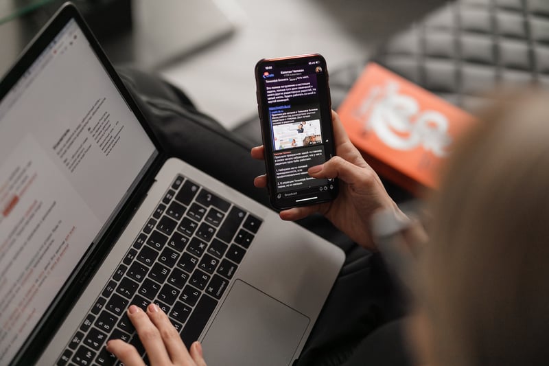 Teacher engaging with school’s social media content, showcasing effective use of hashtags and online communities to attract educators.